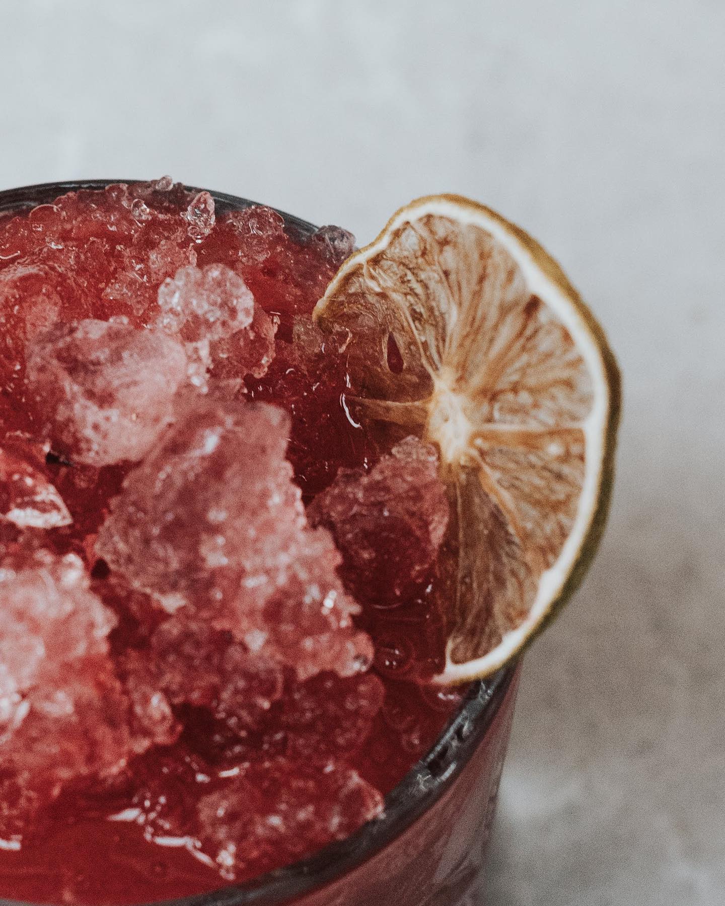 A drink with a dried up lemon and ice to describe Beauty in Photography